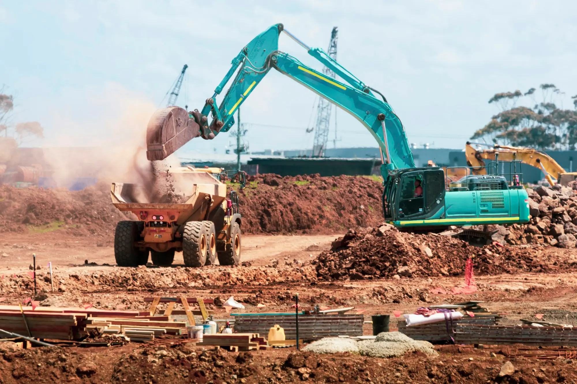 Excavator loading soil into a dump truck on a Melbourne earthmoving site